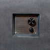 Close-up view of the stainless steel control panel on the Starfire Designs Beton 55" Graphite Rectangle Hidden Propane Tank Gas Fire Pit. This image showcases the precision control knob, electronic igniter, and engraved safety instructions embedded into the textured graphite concrete fire pit body. 