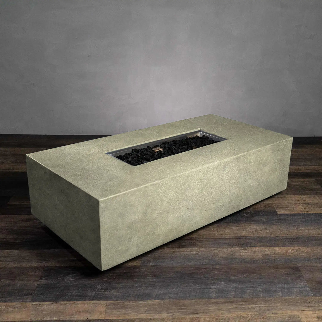 Angled view of Starfire Designs Beton 55-inch rectangle gas fire pit in sand, highlighting its rectangular shape and premium concrete craftsmanship