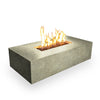 Front-lit view of the Starfire Designs Beton 55-inch rectangle gas fire pit in sand, featuring natural flames over a bed of lava rocks in a white background setting