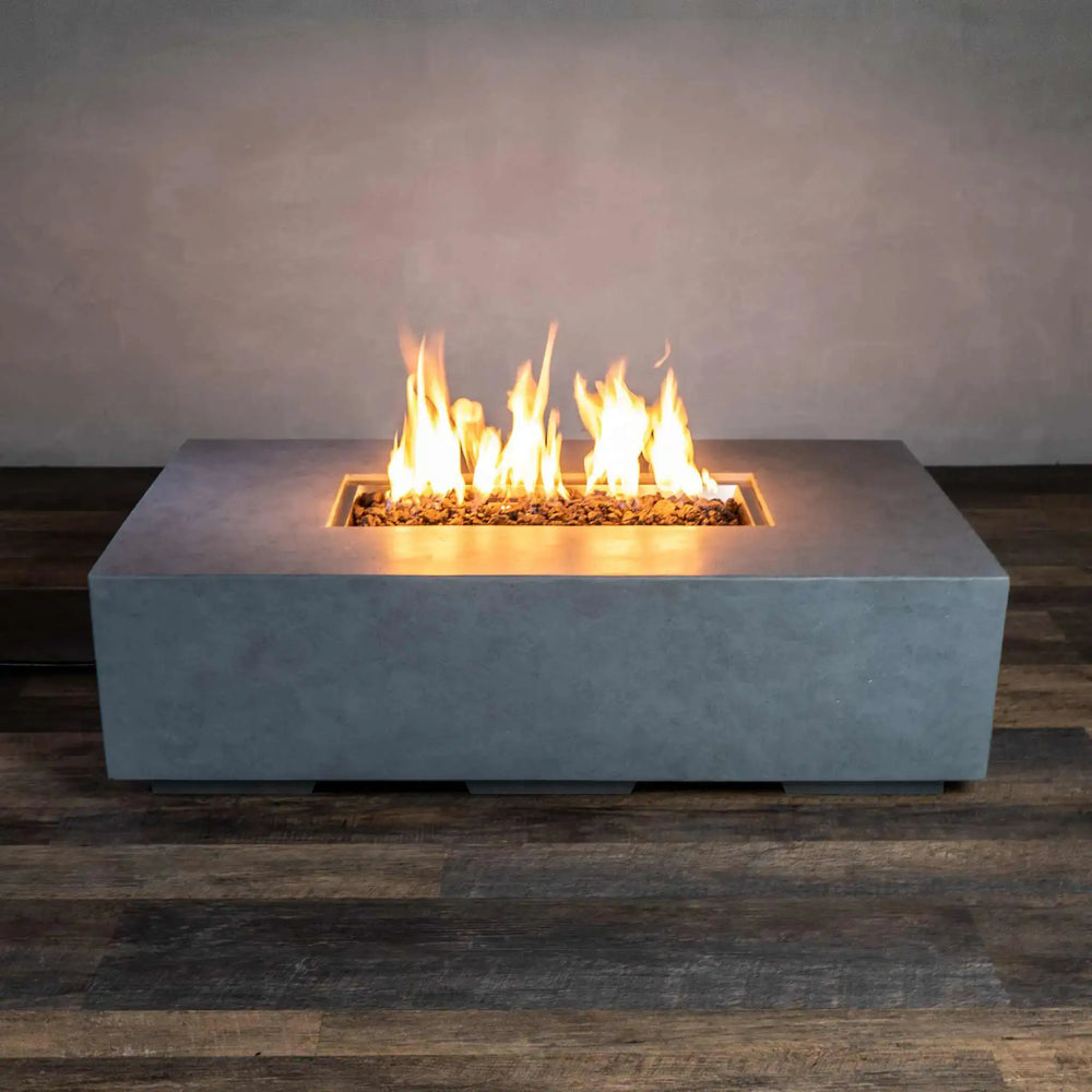 Starfire Designs Beton 55-inch rectangular gas fire pit in natural gray with a contemporary design, showcasing a sturdy concrete base and clean lines. Ideal for modern outdoor spaces, this fire pit includes lava rocks and offers a warm, ambient flame perfect for gatherings.