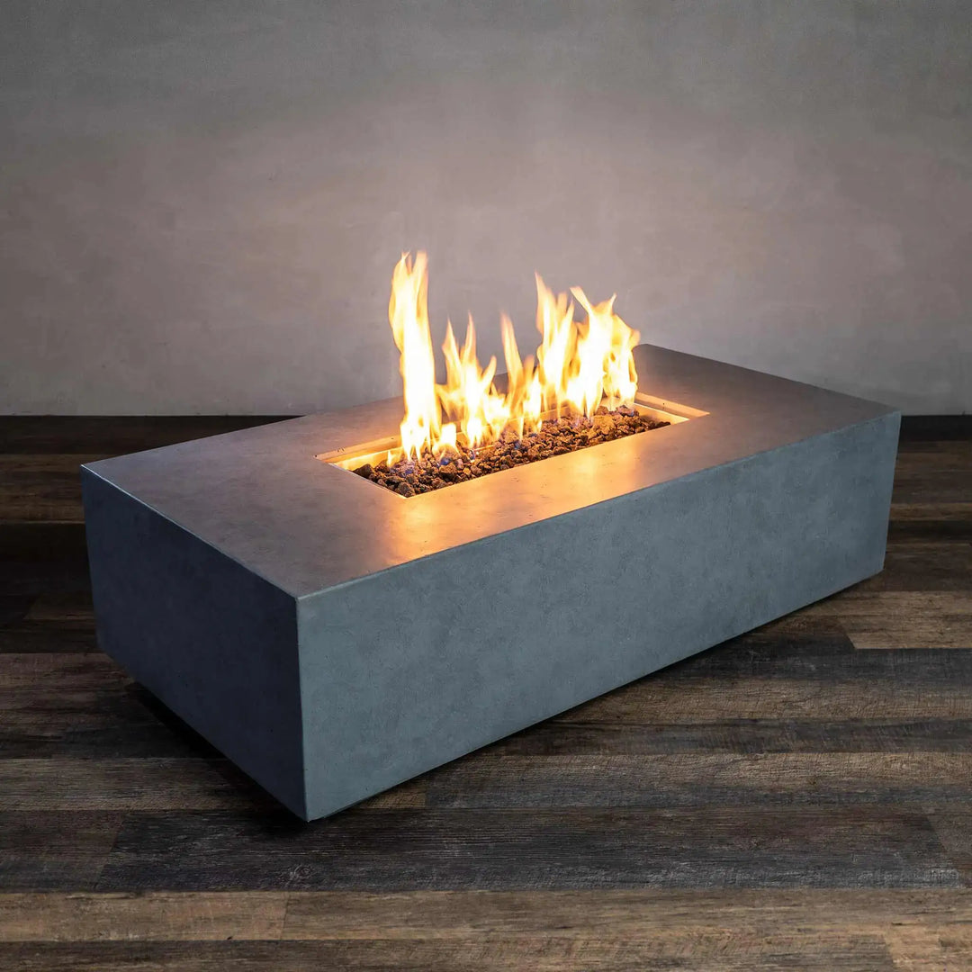 Starfire Designs Beton 55-inch rectangular outdoor fire pit in natural gray, featuring a sleek concrete finish and modern design. This gas fire pit includes lava rock filler and creates a warm and inviting atmosphere, perfect for patios and outdoor gatherings