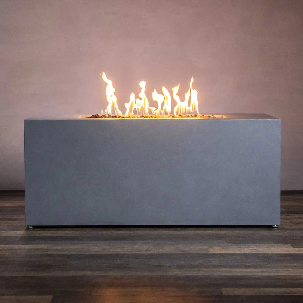 Side view of the Starfire Designs Beton 55" natural gray rectangle gas fire pit with hidden propane tank, featuring elegant flames for a sleek and modern outdoor setting