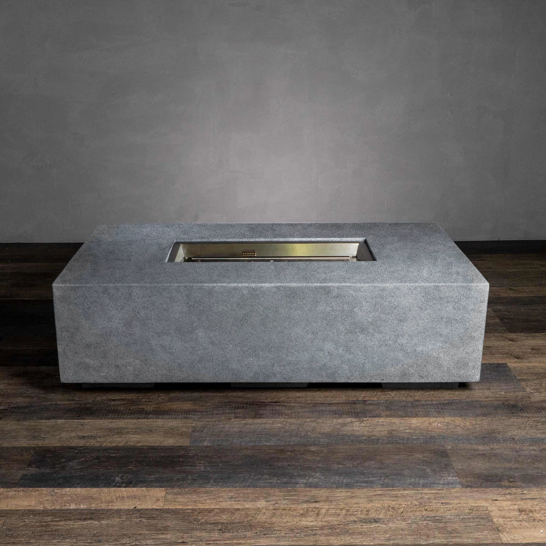  This image of the Starfire Designs Beton 55" Natural Gray Rectangle Gas Fire Pit highlights its sleek and minimalist form without the flames. The durable natural gray concrete structure frames the stainless steel burner, designed for easy ignition and clean functionality when not in use. Its minimalist design suits modern outdoor aesthetics while ensuring durability in various weather conditions. 