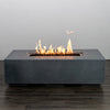 Starfire Designs Beton 55-inch natural gray rectangle gas fire pit with flames fully lit, creating a warm and inviting ambiance for any outdoor setting. The natural gray finish contrasts beautifully against the glowing fire, enhancing the aesthetic appeal of patios and decks.