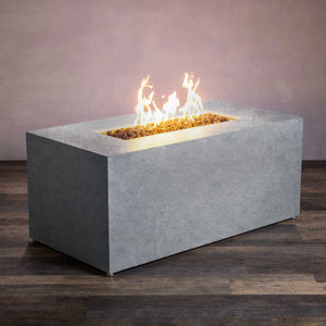 Starfire Designs Beton 55-inch natural gray rectangle hidden propane tank gas fire pit shown from a front angle view. This concrete gas fire pit features a sleek, rectangular design in a smooth natural gray finish. The hidden propane tank compartment is conveniently tucked away, providing a clean and modern outdoor fire pit setup ideal for patio or backyard use