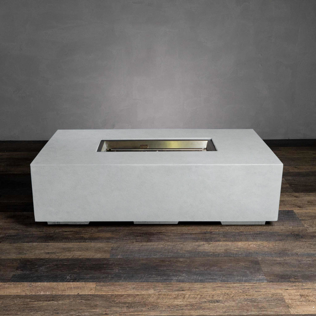  A top view of the Starfire Designs Beton 55" White Rectangle Gas Fire Pit, highlighting the rectangular stainless steel burner set within the white concrete frame. This clean design offers an even and bright flame, perfect for creating a cozy atmosphere in outdoor spaces.