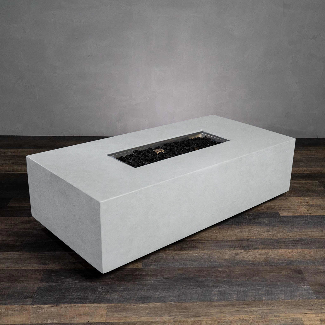 The Starfire Designs Beton 55" White Rectangle Gas Fire Pit with its burner unlit. This image showcases the high-quality stainless steel burner housed within the rectangular white concrete base, designed for durability and elegance in outdoor environments.