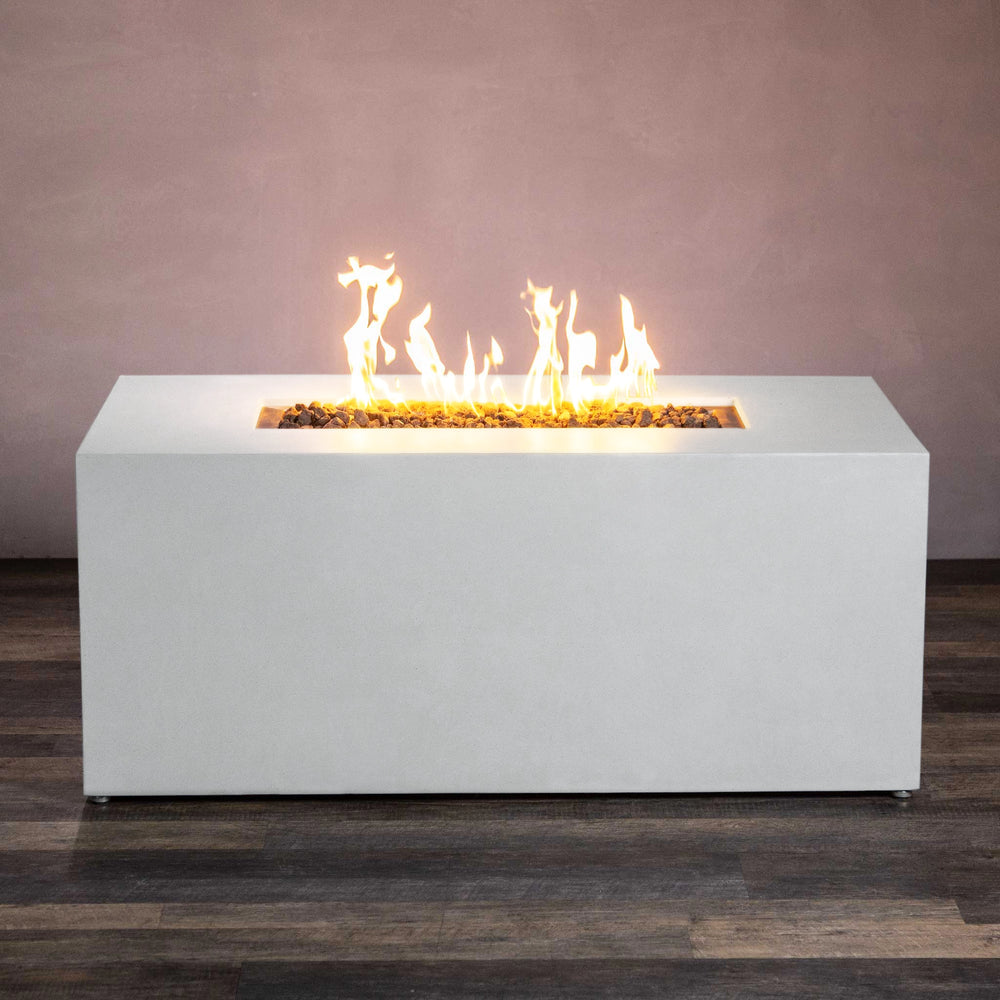 Side view of the Starfire Designs Beton 55" White Rectangle Hidden Propane Tank Gas Fire Pit, highlighting its long rectangular shape and brilliant flames fueled by a concealed propane tank. The white concrete base provides a clean and minimalist look, perfect for contemporary outdoor living areas.