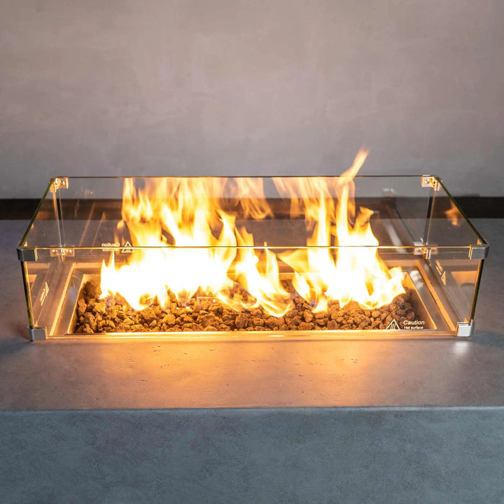 Starfire Designs Beton rectangle gas fire pit with glass wind guard, featuring a hidden propane tank for a sleek and modern look