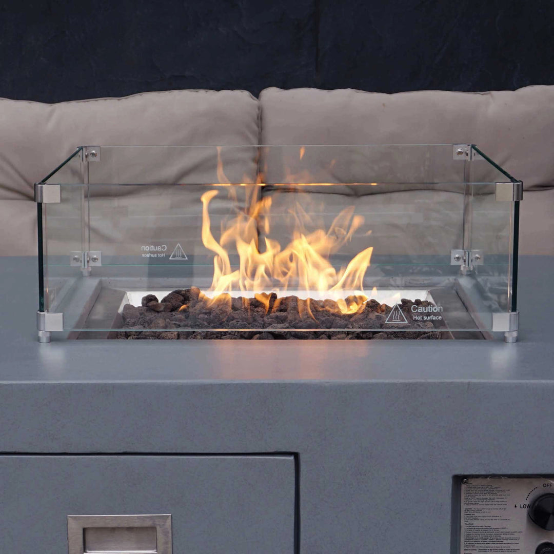 Starfire Designs Beton Square Glass Wind Guard on a modern fire table with flames and glass rocks. Sleek tempered glass panels protect flames, ensuring safety and enhancing the aesthetic of the fire feature. Stylish design complements contemporary outdoor seating areas, perfect for upscale patios or backyard setups