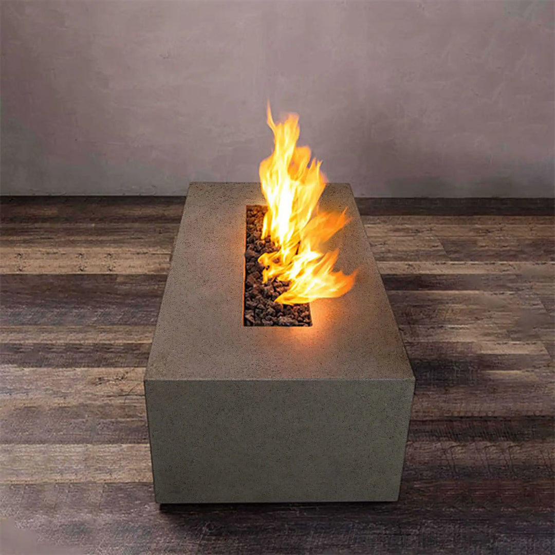 Flames from the Starfire Designs 60-inch by 24-inch brown concrete gas fire pit, perfect for modern outdoor fire pit areas