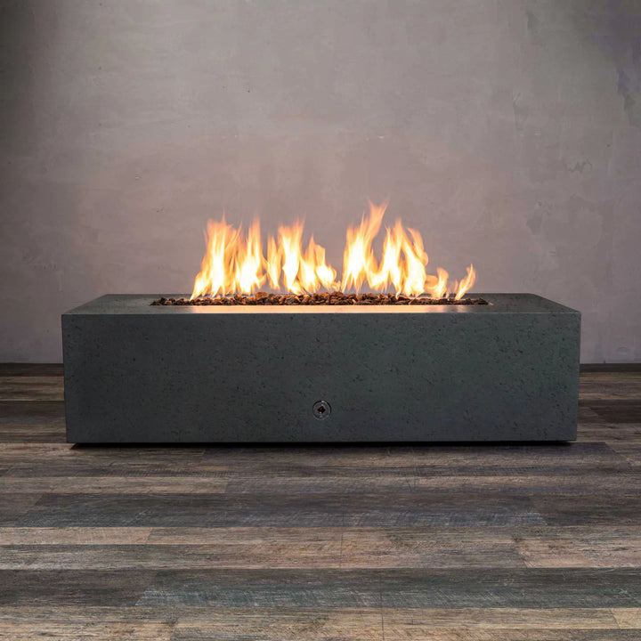 Starfire Designs Concrete Rustic 60-inch by 24-inch Graphite Linear Gravity Gas Fire Pit with flames on, perfect for luxury outdoor fire pits