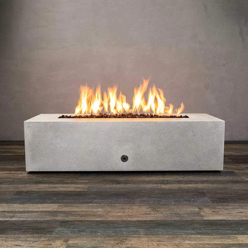 Starfire Designs Concrete Rustic 60-inch by 24-inch Linear Gravity Gas Fire Pit with flames lit, highlighting its modern outdoor fire pit design and use in outdoor patio setting