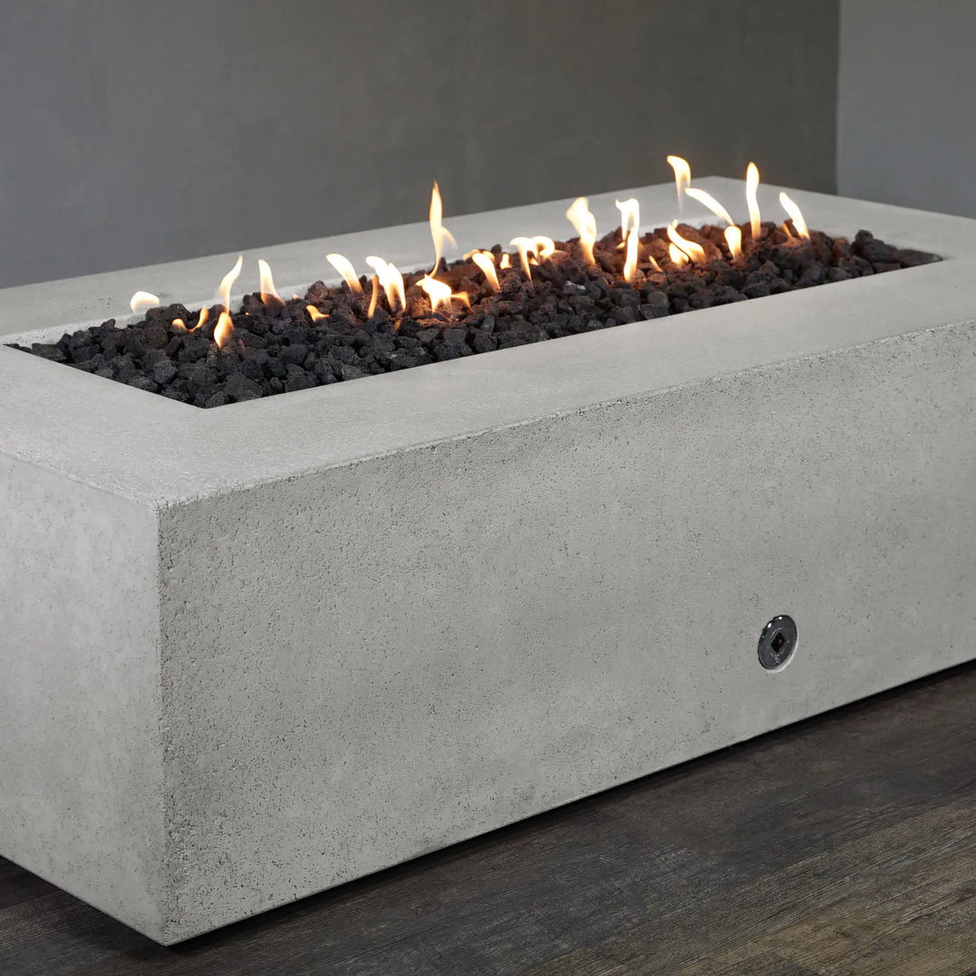 Side view of the Starfire Designs Concrete Rustic 60-inch by 32-inch Rectangle Gravity Gas Fire Pit in White, displaying the smooth concrete surface and elegant gas burner design. The fire pit is an ideal addition to modern patios, providing warmth and ambiance while maintaining a clean, sophisticated look