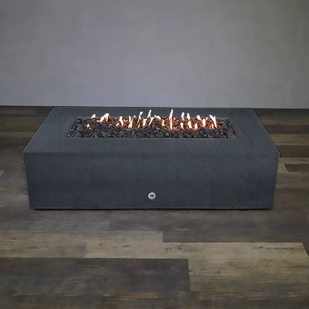 Full view of the lit Starfire Designs Concrete Rustic 72-inch x 38-inch Rectangle Gravity Gas Fire Pit in Graphite, offering a minimalist, modern look with a sturdy concrete build ideal for outdoor environments