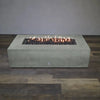 Front view of the Starfire Designs Concrete Rustic 72-inch by 38-inch Rectangle Gravity Gas Fire Pit in natural gray with flames on, capturing the warmth and inviting glow that makes this fire pit an essential addition to any luxurious outdoor space