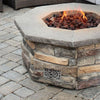 Lifestyle application of the Starfire Designs Decorative Fire Pit Venting Panel - Enoch, installed in a stone fire pit. This panel not only adds a decorative element to outdoor fire pits but also provides necessary ventilation for efficient and safe natural gas fire pit operation