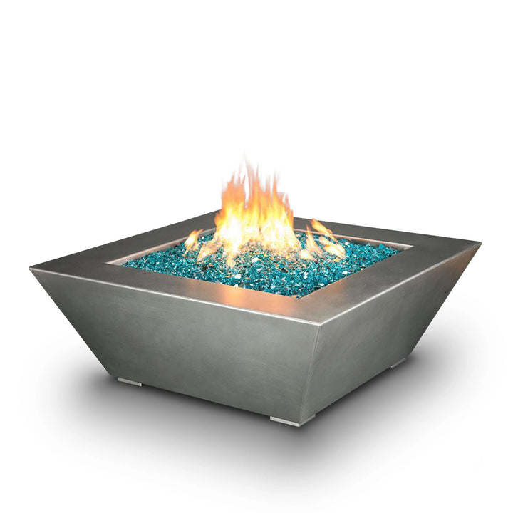 A sleek and modern 48-inch Starfire Designs Edge Stainless Steel Gas Fire Pit set against a white background, showcasing its sharp, geometric lines and durable stainless steel construction. The fire pit is filled with blue fire glass, creating a visually stunning centerpiece for any outdoor space