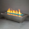 A large 72x40 inch Starfire Designs Edge Stainless Steel Gas Fire Pit, showcasing a sleek and robust stainless steel structure with an expansive bed of blue fire glass. The vivid flames create a captivating display, making this fire pit an ideal centerpiece for expansive outdoor spaces, providing warmth and modern elegance