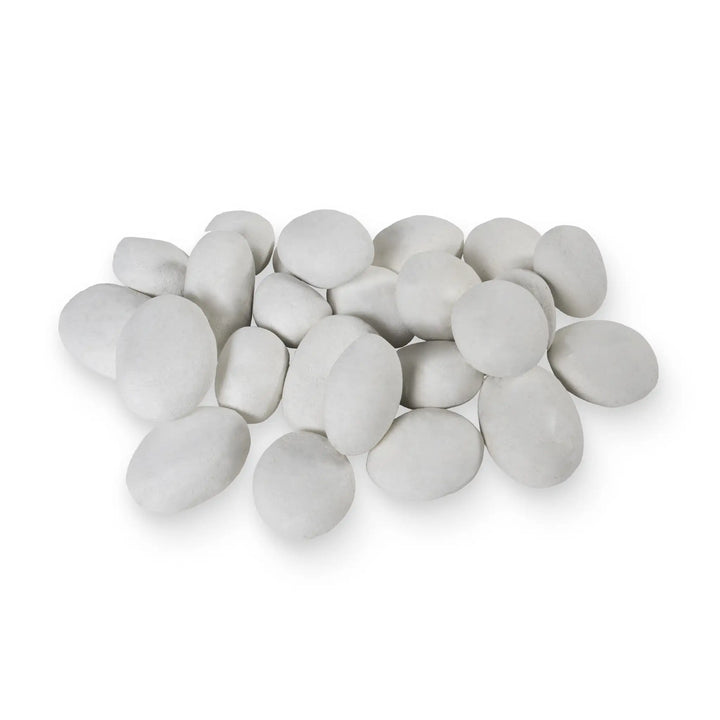 Lifestyle image of Starfire Designs 24-piece white fire pebbles arranged in a fire pit, viewed in close-up to showcase the soft, round shapes and pristine surface of the ceramic stones. The white fire pebbles create a bright, clean look for gas fire pits, providing a contemporary and elegant touch. These heat-resistant pebbles are ideal for outdoor fire features and modern patio decor.