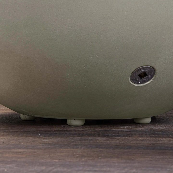 Close-up of the feet design on the Starfire Designs Gravity 36-inch round concrete gas fire pit in beige, emphasizing the sturdy base and adjustable feet, ensuring stability on uneven surfaces and durability in outdoor settings