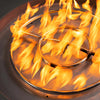 Detailed view of the stainless steel burner in action, with flames on the Starfire Designs Gravity 36-inch Round Concrete Gas Fire Pit in Graphite. The bright, warm flames create a perfect ambiance for outdoor gatherings, highlighting the durable and stylish design