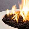 Close-up of the flames and lava rocks in the Starfire Designs Gravity 36-inch round white concrete gas fire pit. The high-quality craftsmanship of the concrete bowl is visible, along with the evenly distributed flames, which add a cozy ambiance to any outdoor area. The natural gas or propane fuel provides reliable and steady heat, perfect for enhancing your backyard or patio experience. The textured surface and glowing fire give this fire pit an upscale, modern look