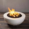 A side view of the Starfire Designs Gravity 36-inch round white concrete gas fire pit with flames. The fire pit showcases a smooth, polished concrete finish in white, perfect for modern outdoor settings. The clean, circular design offers a sophisticated look while the flame illuminates the outdoor space. The bowl-shaped fire pit is durable and resistant to outdoor weather, ensuring long-lasting use. A great addition to outdoor gatherings, providing warmth and a stylish aesthetic