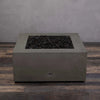 Starfire Designs Gravity 36-inch square gas fire pit in brown without flames, featuring black lava rocks. High-quality concrete construction designed for long-lasting use in outdoor settings. Ideal for those seeking a luxury fire pit for backyards, gardens, or patios