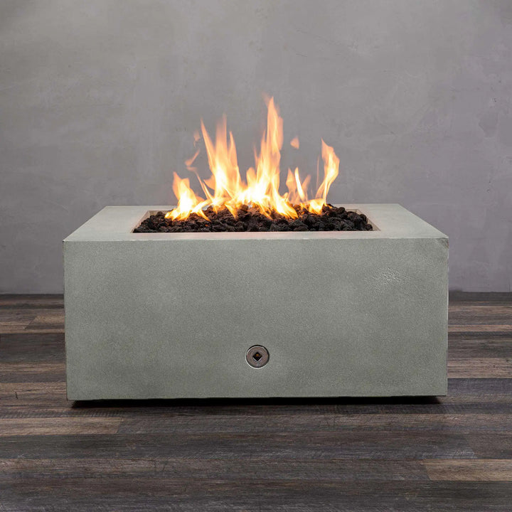 Front view of Starfire Designs Gravity 36-inch Square Concrete Gas Fire Pit in natural gray finish, showcasing a vibrant flame with black lava rocks. Perfect for outdoor spaces, this natural gas fire pit is durable and stylish, built for luxury and functionality in any patio setting. Ideal for landscape projects and residential use