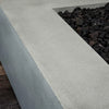 Close-up of the natural gray concrete texture on the Starfire Designs Gravity 36-inch Square Gas Fire Pit. The smooth, durable finish enhances the contemporary look of this fire pit, designed for both style and function in outdoor environments