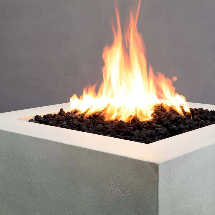 A close-up shot of the intense flames on the Starfire Designs Gravity 36" Square Concrete Gas Fire Pit in white. The clean lines of the square fire pit combined with its high heat output create a visually striking centerpiece