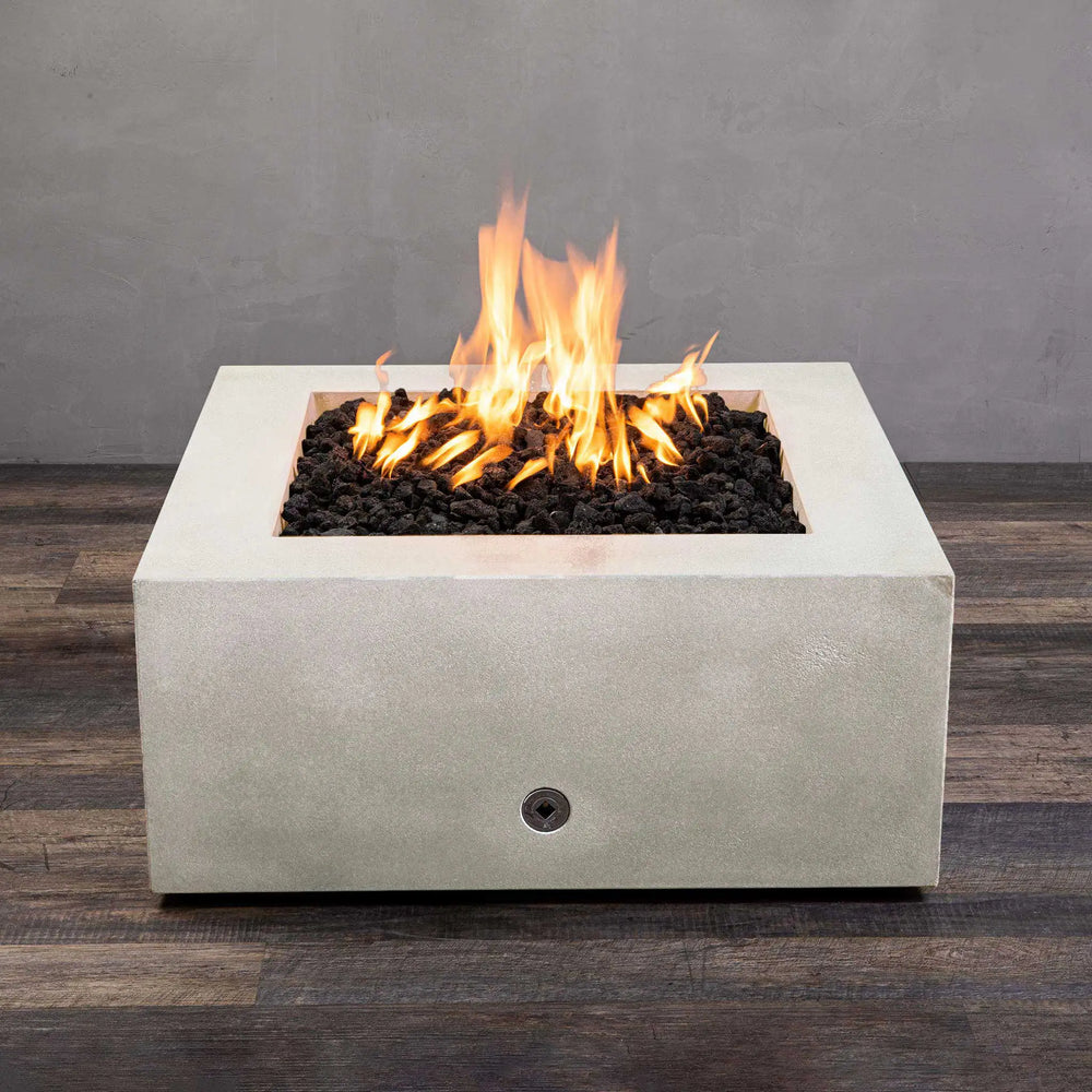 A top-down view of the Starfire Designs Gravity 36" Square Concrete Gas Fire Pit in white, highlighting the vivid flames over the lava rock. The crisp white concrete finish provides a contemporary look, ideal for luxury outdoor settings