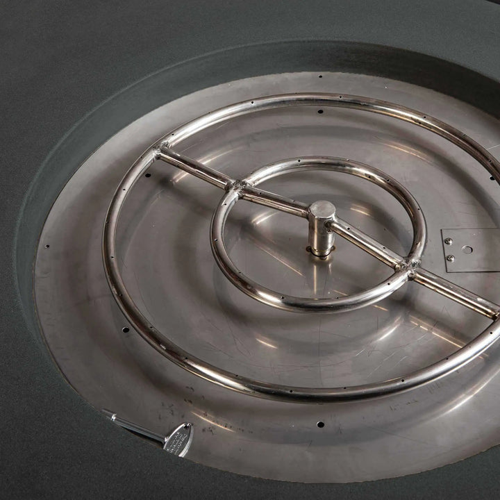 Close-up of the burner inside the Starfire Designs Gravity 45-inch Round Gas Fire Pit in Graphite. This image showcases the high-quality burner system, providing efficient heat distribution. The fire pit is crafted with weather-resistant concrete and designed for both style and functionality. Graphite burner system, luxury gas fire pit, durable concrete fire feature.