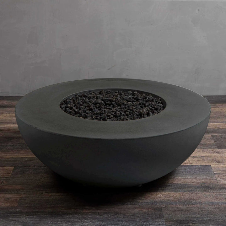 Starfire Designs Gravity 45-inch Round Concrete Gas Fire Pit in Graphite, filled with premium lava rocks. The robust design and elegant Graphite finish make this fire pit an ideal choice for creating a focal point in outdoor spaces. Weather-resistant and perfect for both residential and commercial settings. Graphite gas fire pit, durable concrete fire feature, modern outdoor fire design