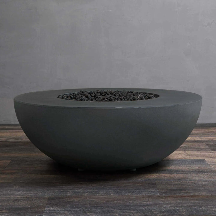 Graphite Starfire Designs Gravity 45-inch Round Concrete Gas Fire Pit with no flame, highlighting its smooth, matte concrete surface and central lava rock feature. Designed to withstand the elements, this high-end fire pit is perfect for upscale outdoor spaces, offering a sophisticated look and reliable function. Graphite luxury fire pit, outdoor concrete fire feature, weather-resistant design