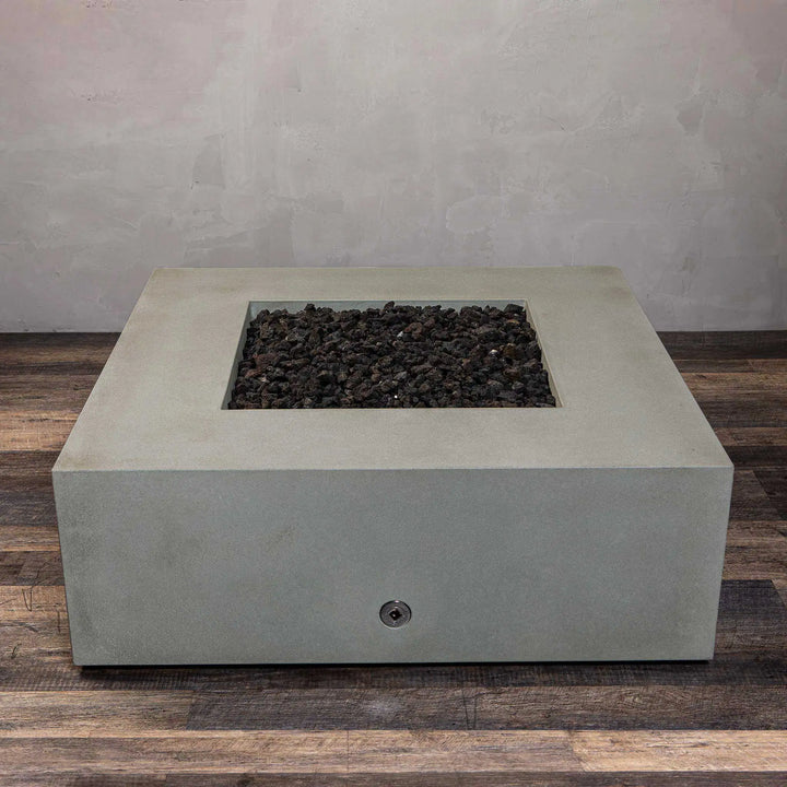 Top-angle view of the Starfire Designs Gravity 45" Square Concrete Gas Fire Pit in beige, without the flame, revealing a clean, minimalist design with dark lava rocks. The fire pit provides a sleek and modern focal point for outdoor areas, combining function and style.