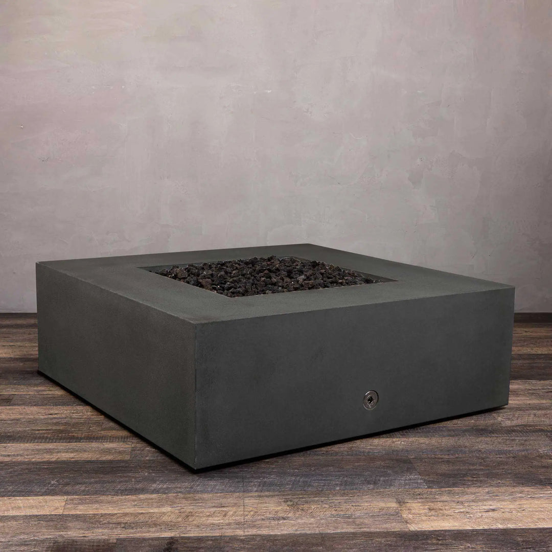 Front view of Starfire Designs Gravity 45-inch square gas fire pit in graphite, highlighting the stainless steel burner. With the lid removed, the burner is ready for operation, offering a durable and efficient heating source for outdoor spaces. The smooth, sleek graphite finish complements the industrial look of the burner.