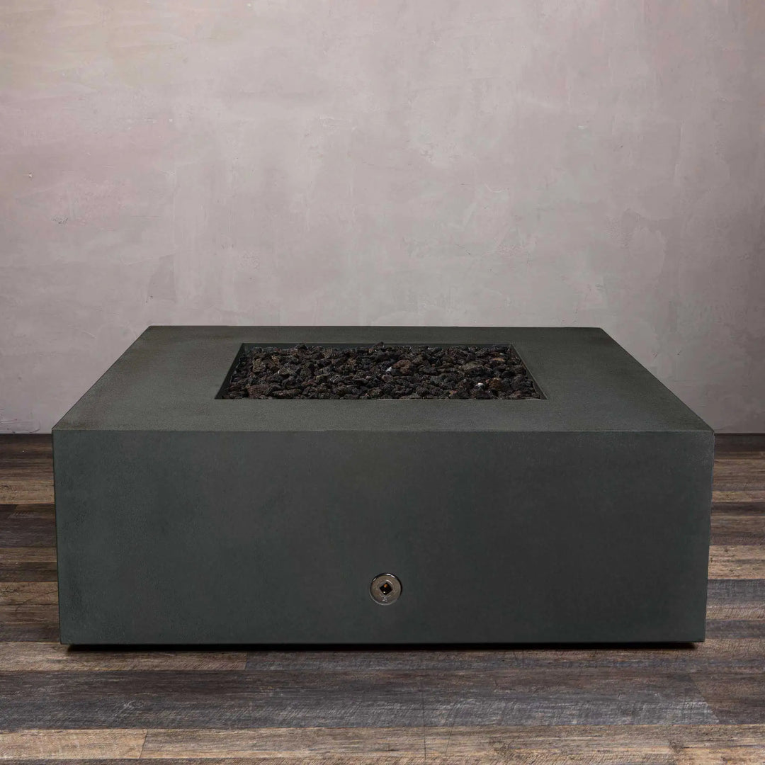 Front view of Starfire Designs Gravity 45-inch square gas fire pit in graphite finish without flames, showcasing a bed of lava rocks. This contemporary fire pit is crafted from high-quality concrete, providing weather resistance and a long-lasting centerpiece for any outdoor living space. The graphite color gives a modern, understated look, perfect for a variety of outdoor design aesthetics.