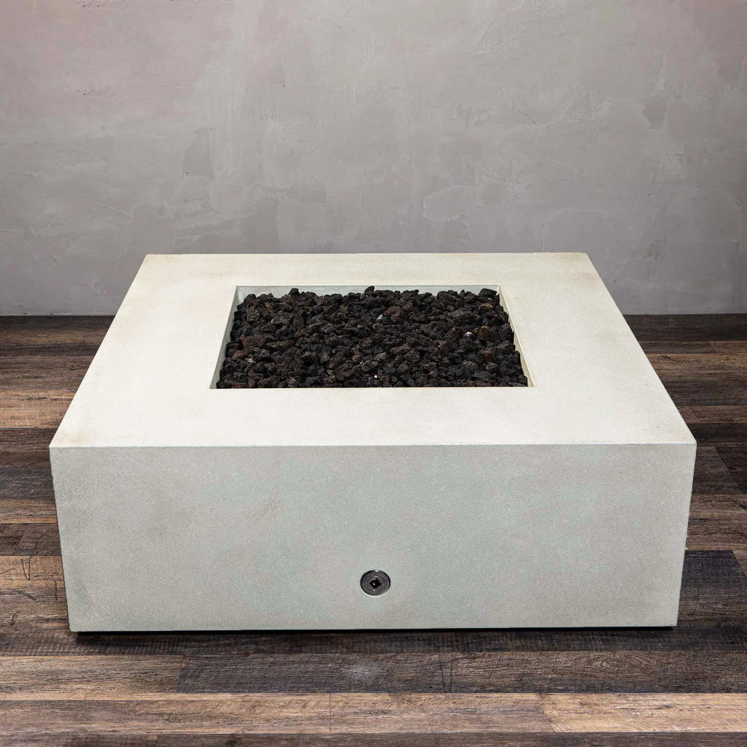 Top view of the Starfire Designs Gravity 45-inch Square Concrete Gas Fire Pit in white, showing its symmetrical design with the fire bowl filled with black lava rocks. This gas-powered fire pit is designed for outdoor use and delivers both warmth and style