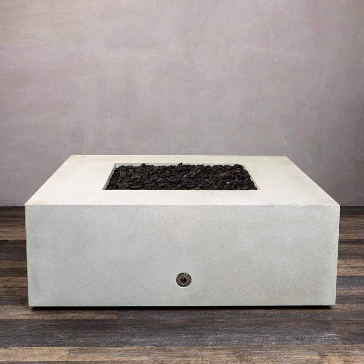 The Starfire Designs Gravity 45-inch Square Concrete Gas Fire Pit in white without flames, highlighting its smooth, clean-lined surface and central fire bowl filled with dark lava rocks. The modern concrete design adds an upscale look to patios or garden areas