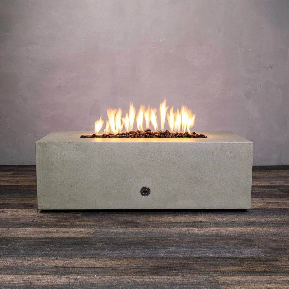 Starfire Designs Gravity 48-inch x 32-inch rectangle concrete gas fire pit in beige finish with bright flames and lava rocks, front view. Modern outdoor fire pit for luxury patio settings, made from durable concrete, suitable for natural gas