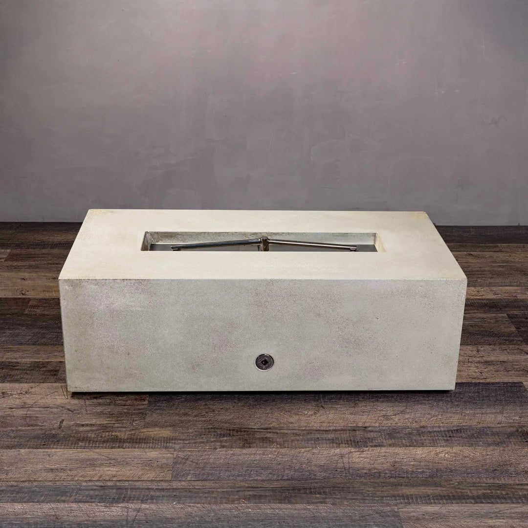 A close-up of the burner system on the Starfire Designs Gravity 48" x 32" Rectangle Concrete Gas Fire Pit in white. The stainless steel burner assembly ensures long-lasting durability, while the sleek rectangular shape adds sophistication to outdoor spaces.