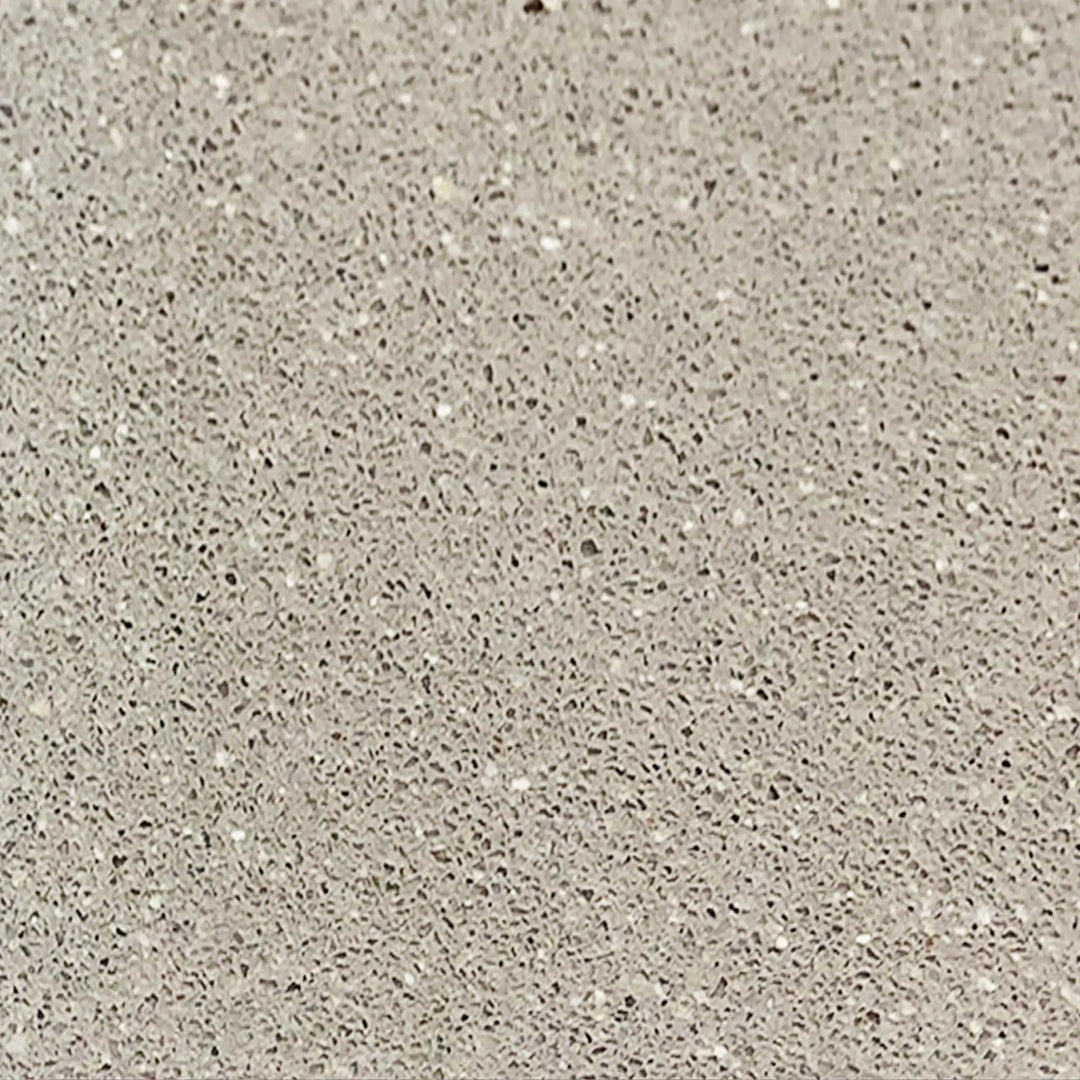 Close-up texture of the beige swatch for the Starfire Designs Gravity 60 x 24 inch Linear Concrete Gas Fire Pit. The surface showcases a fine, speckled pattern in light beige, providing a natural, earthy look. Perfect for blending seamlessly with outdoor environments while adding a touch of elegance to any patio setting. Durable concrete construction ensures longevity and resilience against weather elements