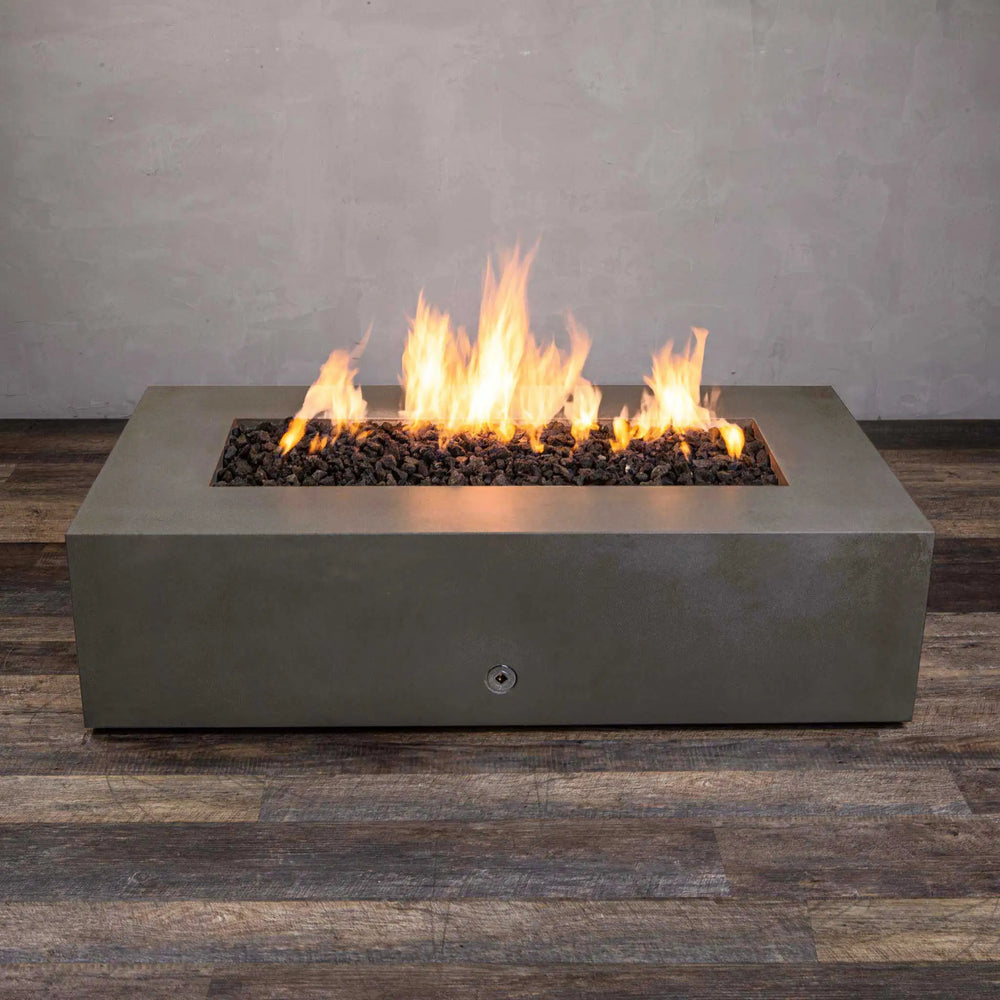 Side view of the Starfire Designs Gravity 60" x 32" Brown Rectangle Concrete Gas Fire Pit, highlighting the even flames and premium brown concrete structure. This gas fire pit is perfect for patios or garden spaces.