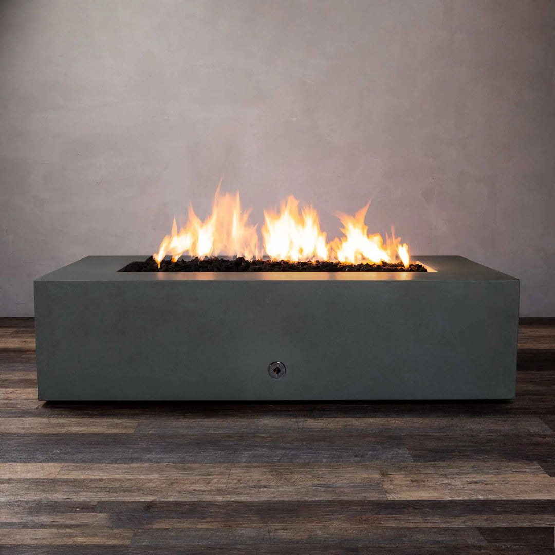 Starfire Designs Gravity 60" x 32" Rectangle Concrete Gas Fire Pit in Graphite, showcasing a sleek modern design with smooth concrete finish. The pit features a wide rectangular burner with vivid flames, ideal for outdoor entertaining. Perfect for contemporary patios, this fire pit is built to withstand various weather conditions. Concrete fire pit, natural gas fire pit, outdoor patio centerpiece