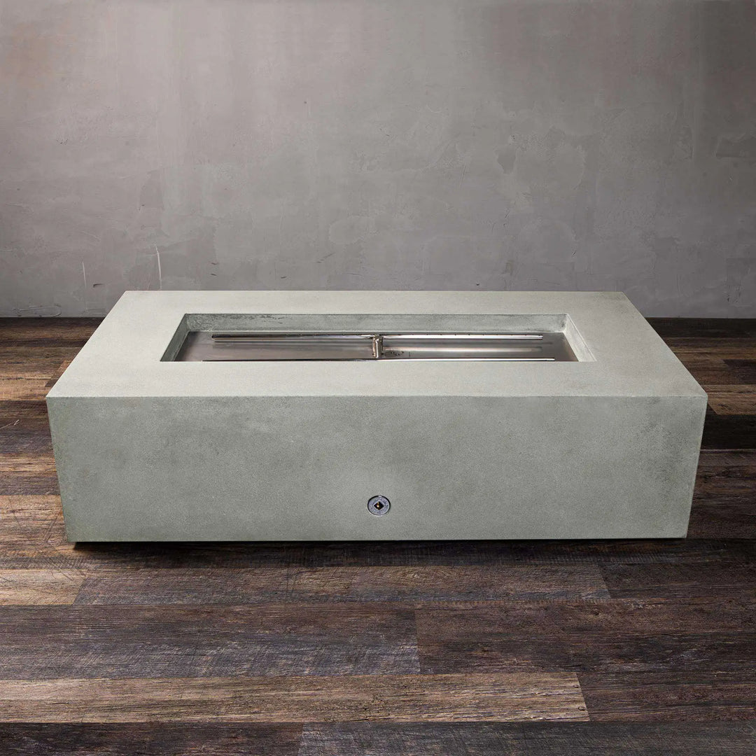 Top-down view of the Starfire Designs Gravity 60" x 32" rectangle concrete gas fire pit in natural gray, showing the stainless steel burner system without flames. This sophisticated fire pit features a durable burner designed to distribute heat evenly. Its versatile design can accommodate various outdoor seating arrangements, making it an excellent choice for high-end residential and commercial settings.