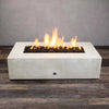 A top view of the Starfire Designs Gravity 60" x 32" Rectangle Concrete Gas Fire Pit in white with flames visible. The rectangular fire pit showcases its clean, modern lines, ideal for enhancing outdoor areas with a contemporary touch. Made from high-quality concrete, this gas fire pit is perfect for creating a cozy outdoor ambiance.