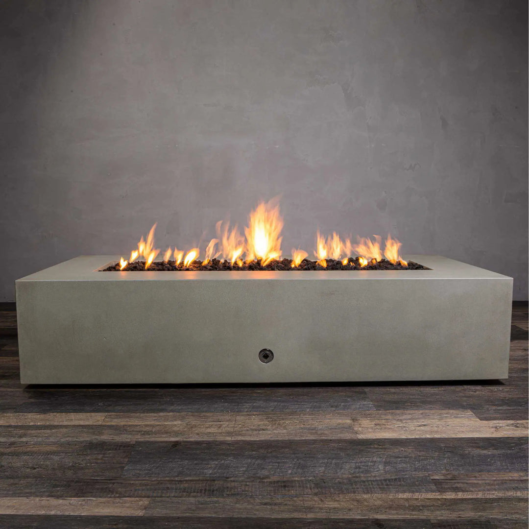 Starfire Designs Gravity 72-inch x 38-inch rectangular beige concrete gas fire pit, shown with a lively flame. The clean and modern design of this fire pit adds warmth and elegance to outdoor living spaces. Features a wide concrete frame and durable construction ideal for both residential and commercial use