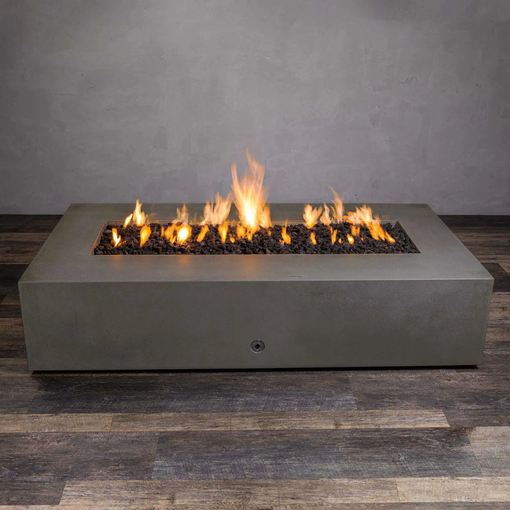 Front-facing image of the Starfire Designs Gravity 72x38 concrete gas fire pit in brown, with flames active. Its natural lava rock bed complements the long-burning fire, creating a cozy outdoor atmosphere. The large fire pit is designed for modern outdoor settings, providing elegance and functional warmth.